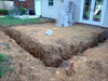 Footings dug and rebar installed.  Ready for concrete.  Notice �L� shaped block; this will be used on the top course as a form for the concrete slab.