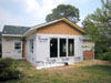 Framing complete. New roofing on all. Windows installed. Siding started.