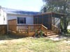 Refurbished deck with new screened room.  New roof and gutters on house.