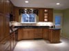 Dark Oak Cabinets with Black Granite.  Integrated Drawer Dishwashers to right of Sink.  Built-in Oven with Drop-in Stove. Under Cabinet Lighting with Lit Accent Cabinet.